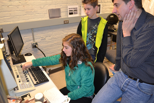 Joe Muskin (right) works with two Danville Luteran students on the SEM.